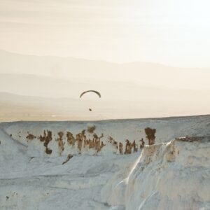 Pamukkale paragliding over the white terraces at sunset