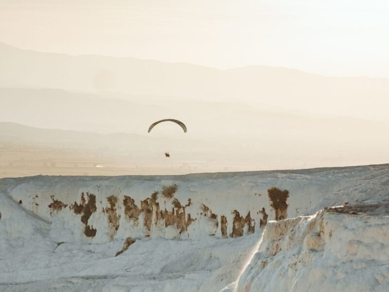 Pamukkale paragliding over the white terraces at sunset